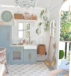 a kitchen with blue cabinets and white walls