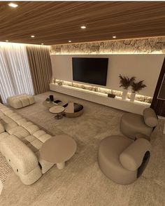 a living room filled with lots of furniture and a flat screen tv mounted on the wall