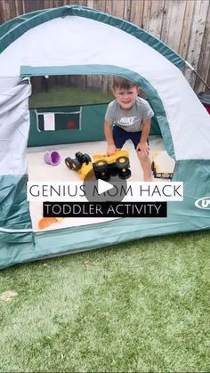 a little boy playing in a play tent with his toy truck on the ground and text genius tom hack toddler activity