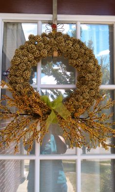 a wreath is hanging on the window sill