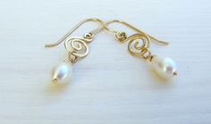 "Delicate dangle gold filled and pearls earrings. These romantic Boho earrings are made of high-quality 14K gold filled and have each a teardrop pearl hanging from a gold filled spiral. The dangling pearls and the spiral wire element give the earrings a romantic vintage look. The earrings are made from high quality 14K \"Gold Filled\" - unlike \"gold plating\" the gold in gold filled jewelry is mechanically bonded to the base metal, and it will not wear off or turn black These lovely earrings ar Dainty Handmade Gold Pearl Earrings, Dainty Gold Wire Wrapped Pearl Earrings, Delicate Gold Pearl Earrings Nickel Free, Delicate Handmade Gold Pearl Earrings, Nickel-free Gold Pearl Earrings For Wedding, Earrings Gold Pearl, Drop Pearl Earrings, Chainmail Necklace, Pearl Earrings Gold