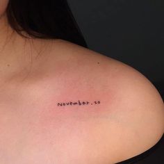 a woman's shoulder with the word november written in cursive font on it