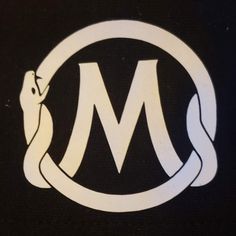 the letter m is inscribed in a circle with a snake on it's side