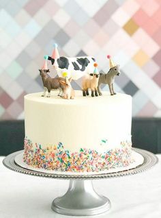 a cake decorated with farm animals and sprinkles