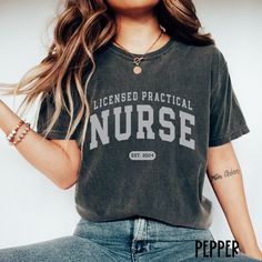 This LPN Shirt / Nurse Comfort Colors Shirt makes a great nurse graduation gift for the 2024 Graduate - or buy for yourself!  Perfect for work or play! Gorgeous color options and fabulous fit!   **UNISEX SIZING**   ♥ W E L C O M E  T O  S K E T C H Y  C A T  D E S I G N S ! ♥ * This is a standard unisex garment-dyed 100% cotton shirt - Comfort Colors Tee with a relaxed fit. FOR AND OVERSIZED TEE, PLEASE SIZE UP!!  Please review the size chart to ensure you receive the fit you want. ♥ Click here to return to our shop's home page ⇒  https://www.etsy.com/shop/SketchyCatDesigns * Q U I C K * F A C T S * ♥ 100% cotton medium weight shirt ♥ Design is high quality digital print ♥ For long-lasting print results, wash inside out in cold water ONLY. ♥ For drying, I recommend laying flat to dry howev Lpn Shirts, Scrub Outfits, Graduation Nursing, Graduate Nurse, 2024 Graduate, Gifts For Nurses, Scrubs Outfit, Nurse Shirts, Nurse Graduation