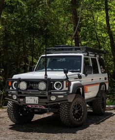 an off road vehicle parked in the woods