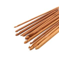 six wooden knitting needles lined up on top of each other