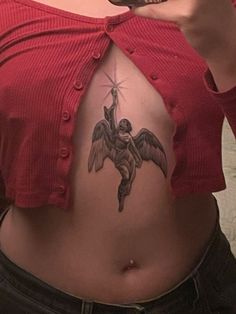 a woman with a tattoo on her stomach taking a selfie