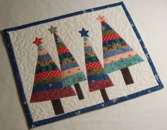 a quilted christmas card with three trees on it