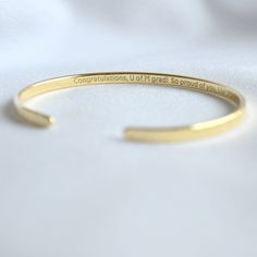 Looking for the perfect gift? Our Personalized Bracelet is a heartfelt way to show your loved ones how much you care. Ideal for birthdays, anniversaries, and graduations! - 22K Gold plated bracelet engraved with your chosen message. - The  thickness of gold plating is around 0.5 microns (it's sufficient even for jewelry pieces that are exposed to rough wear) - Text, coordinates, numbers outside or inside the cuff  - Up to 90 characters  on each side - Approximately 3mm wide, 6.3'' standard women Minimalist Engraved Text Bracelet For Gift, Gold Engraved Bracelet For Best Friend, 90 Characters, Grave Plaques, Do Hard Things, Personalized Bracelet, Motivation Quote, Gold Engraving, Engraved Bracelet