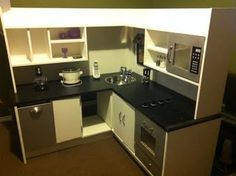 a small kitchen with black counter tops and white cabinets