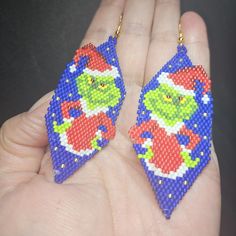 Elevate Your Holiday Style With These Handmade Beaded Christmas Grinch Earrings. Expertly Crafted, Each Pair Features Vibrant Beads That Capture The Whimsical Essence Of The Beloved Grinch Character, Making Them A Perfect Accessory For Festive Gatherings. Lightweight And Comfortable, These Earrings Are Designed To Add A Playful Touch To Any Outfit While Celebrating The Spirit Of The Season. Christmas Earrings With Colorful Beads, Grinch Beaded Earrings, Seed Bead Grinch Earrings, The Grinch Beaded Earrings, Beaded Grinch Earrings, Christmas Dangle Beaded Earrings With Colorful Beads, Christmas Colorful Beaded Dangle Earrings, Grinch Earrings, Grinch Characters