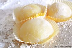 three pastries sitting on top of a table covered in powdered sugar