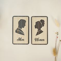 two wooden magnets depicting the silhouettes of women