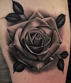 a black and white rose tattoo on the arm