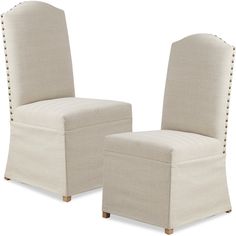 a pair of beige chairs with buttons on them