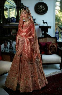 a woman in a red and gold bridal gown