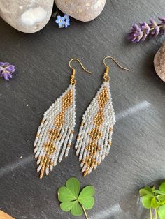 These earrings are perfect for a Hippie boho bride on her wedding day. The different textures and finishes of the white beads would be a perfect match to most wedding dresses. and if you are not getting married, fear not!! As these are also perfect summer holiday earrings to dazzle on an evening out or to stand out around the pool! These would make a perfect gift for a mum, sister, friend, girlfriend, wife.  Material: Miyuki and Czech seed beads woven using durable black thread. Technique: brick Wedding White And Gold, Bohemian Wedding Earrings, Earring Inspired, Christmas Party Wear, Paper Bow, Friend Girlfriend, Wife Material, Holiday Earrings, Beaded Wedding