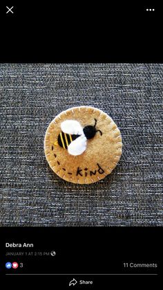 a cookie with a bee on it and the words kind written on it is shown