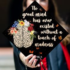 a person wearing a graduation cap that says no great mind has ever excited without a touch of madness