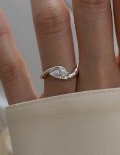 a woman's hand with a diamond ring on it