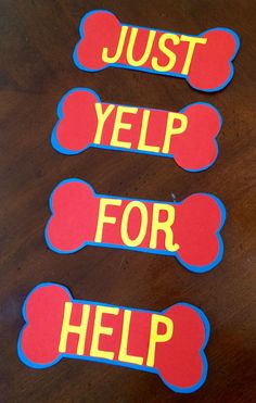 three stickers with the words just yelp for help on them, sitting on a table