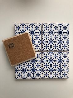 blue and white tile with a cork coaster