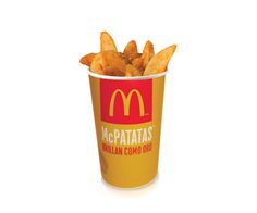 french fries in a paper cup with the word mcp patatas written on it