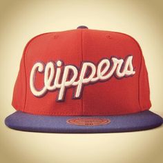 a red and purple cap with the word clippers on it's front side