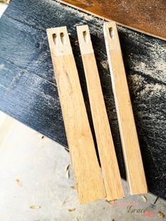 two wooden skis sitting next to each other