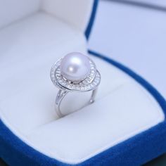 11-12mm Freshwater Pearl This popular ring design features AAAA quality, round freshwater pearls measuring 11-12mm. Material: Freshwater Pearl with 925 sterling silver, cubic zirconia Product Information Pearl Type Freshwater Pearl Origin China Shape Round Quality AAAA Size 11-12mm Nacre Very Thick Color Purple / White Luster Very High White Gold Pearl Ring With Pearl Drop, Diamond White Akoya Pearl Ring, Anniversary Pearl Ring, Silver Akoya Pearl Ring With Pearl Drop, Pearl Jewelry Ring, Pearl Centerpiece, Pearl Rings, Popular Rings, Pearl Types