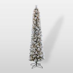 a white christmas tree with snow on it