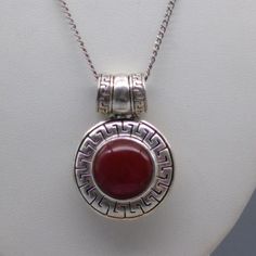 "Shimmering Magenta Circle Pendant Necklace, Vintage Round with Greek Key Frame on Silver Tone Chain 18\" chain; 1-1/2\" x 1\" pendant unmarked Very Nice Condition, Gently Used Size: Womens 18\" Condition: Pre-Owned Good" Vintage Round Box Chain Necklace, Red Engraved Round Necklace, Red Engraved Round Necklaces, Vintage Sterling Silver Round Chain Necklace, Formal Round Pendant Necklace Stamped 925, Antique Chain Necklace As Gift, Antique Round Chain Necklace Gift, Key Frame, Pendant Necklace Vintage