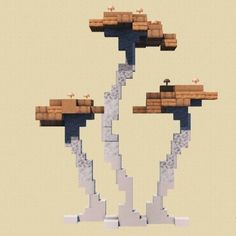 three trees made out of lego blocks in the shape of two people standing on top of them