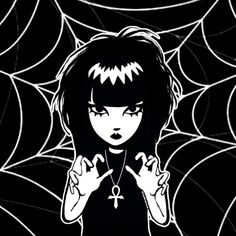 a girl with black hair is holding her hands up in front of a spider web