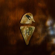 a close up of a wooden door with a metal object on it's side