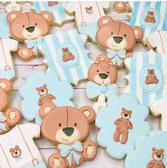 teddy bears and other cookies are arranged on top of a table with blue and white stripes