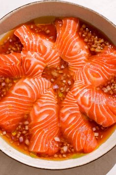 a bowl filled with salmon and lentils on top of a table