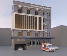 an ambulance is parked in front of a building with multiple stories and lights on it