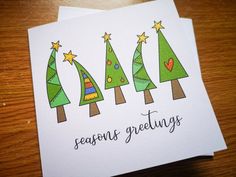 three greeting cards with christmas trees on them