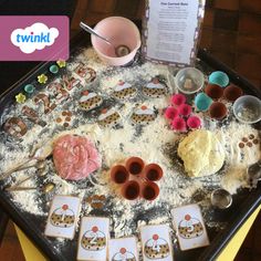 a table topped with lots of different types of food on top of a black tray