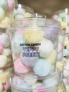 cotton candy in plastic containers with the words yelppy sweets written on one side