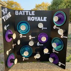 a sign with purple and blue plates on it that says xd time battle royale