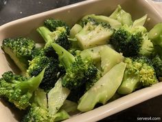 broccoli florets in a white dish on a table