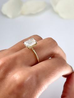 a woman's hand with a ring on it and a diamond in the middle