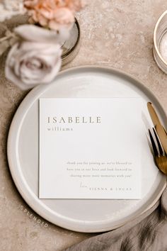 a table setting with place cards and silverware