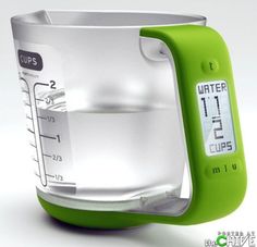 a green and white measuring cup with an alarm clock on it