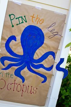 a sign with an octopus on it that says pin the octopus in the octopus's mouth