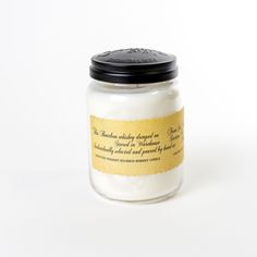 a white jar with a black lid and label on the top that says, we are making holiday candles for our loved one's birthday