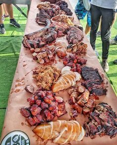 a table topped with lots of different types of meats and veggies on top of it